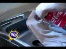 A hand dusting on a DIY cleaning solution on a greasy white piece of fabric.
