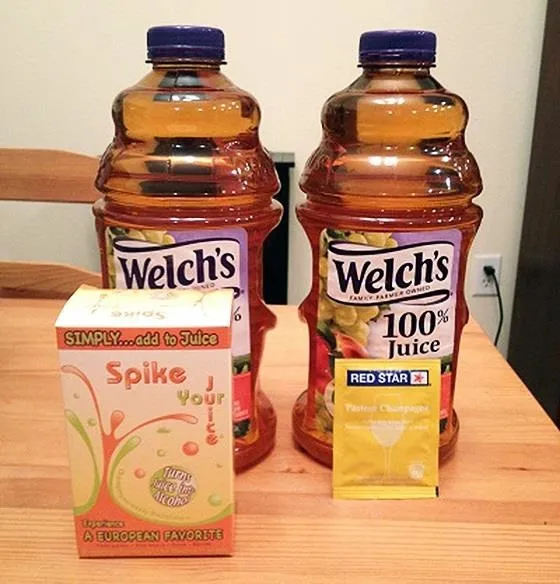 Two bottles of Welch's 100% Juice beside a box of Spike water and a packet of drink mix.