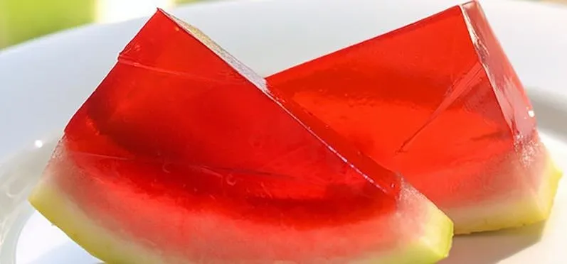 Red gelatin dessert served on a plate.