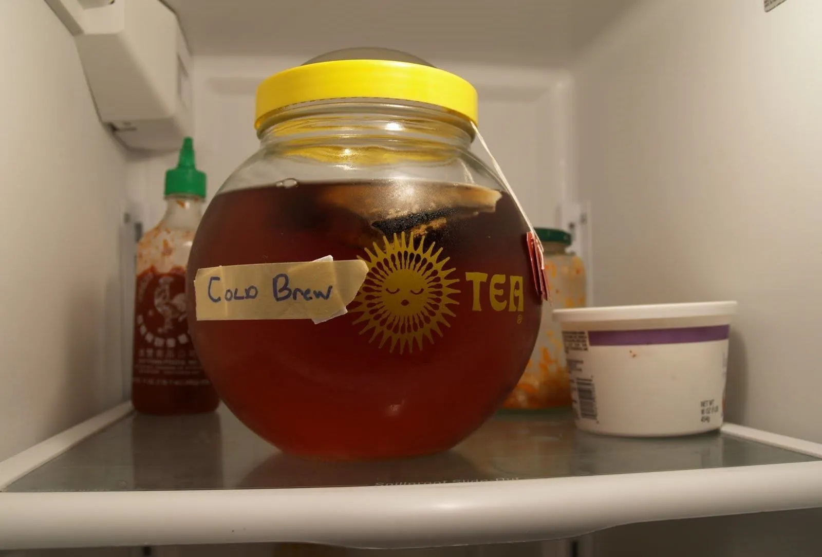 Cold brew tea in a jar inside a refrigerator.