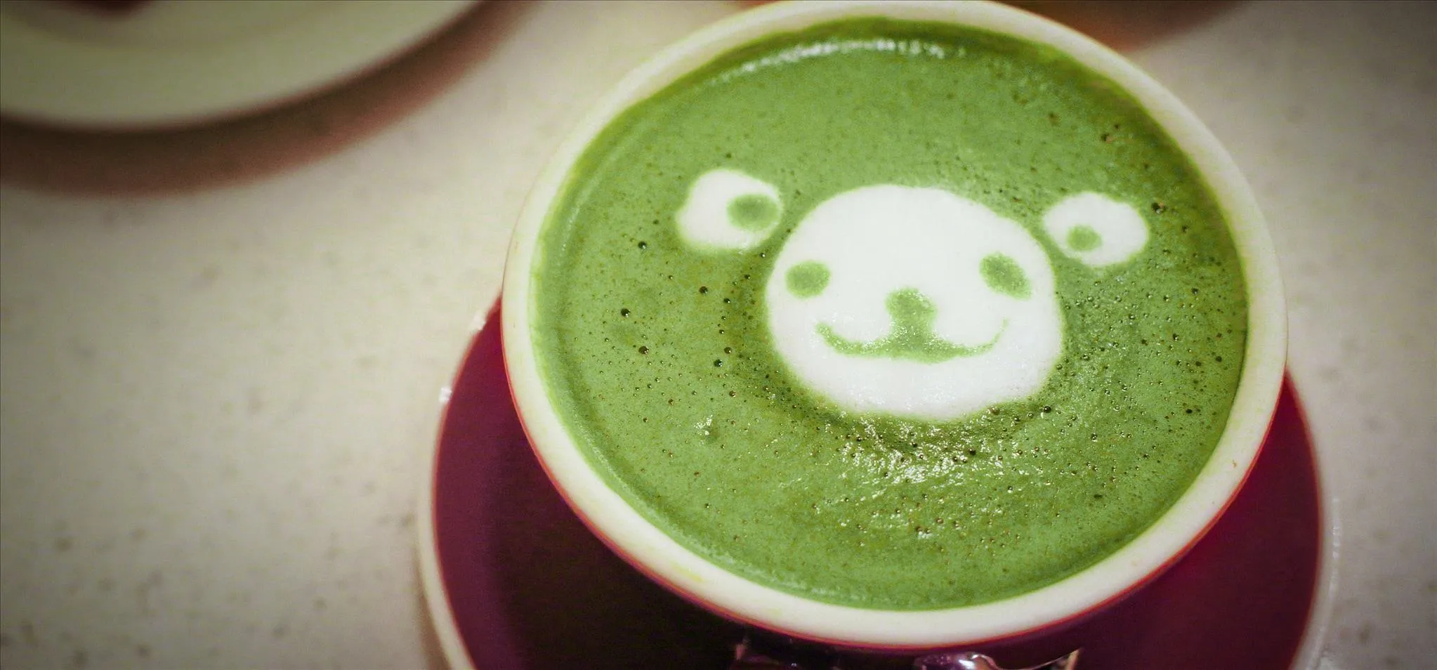 Matcha latte with a panda design on top