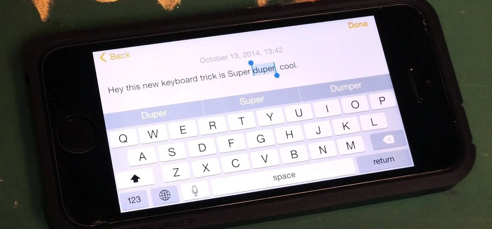 Mobile phone displaying a text message with an on-screen keyboard.