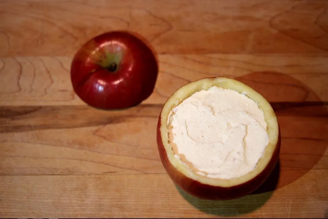 Apple hollowed out and filled with cream.