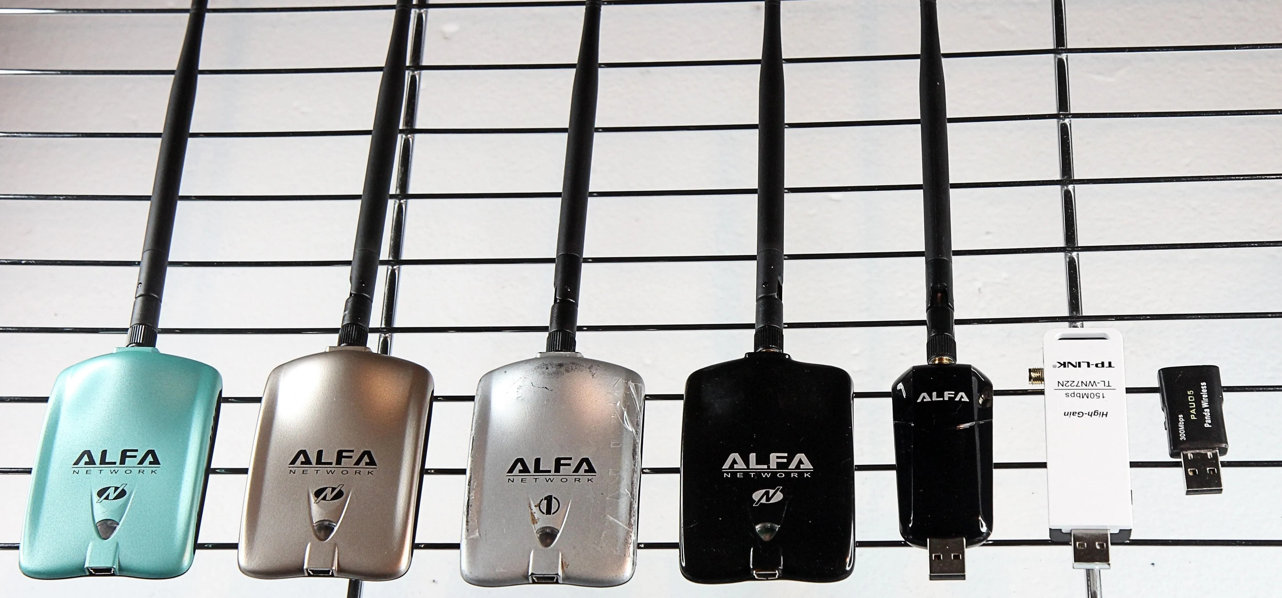 Various USB Wi-Fi adapters on a display shelf.