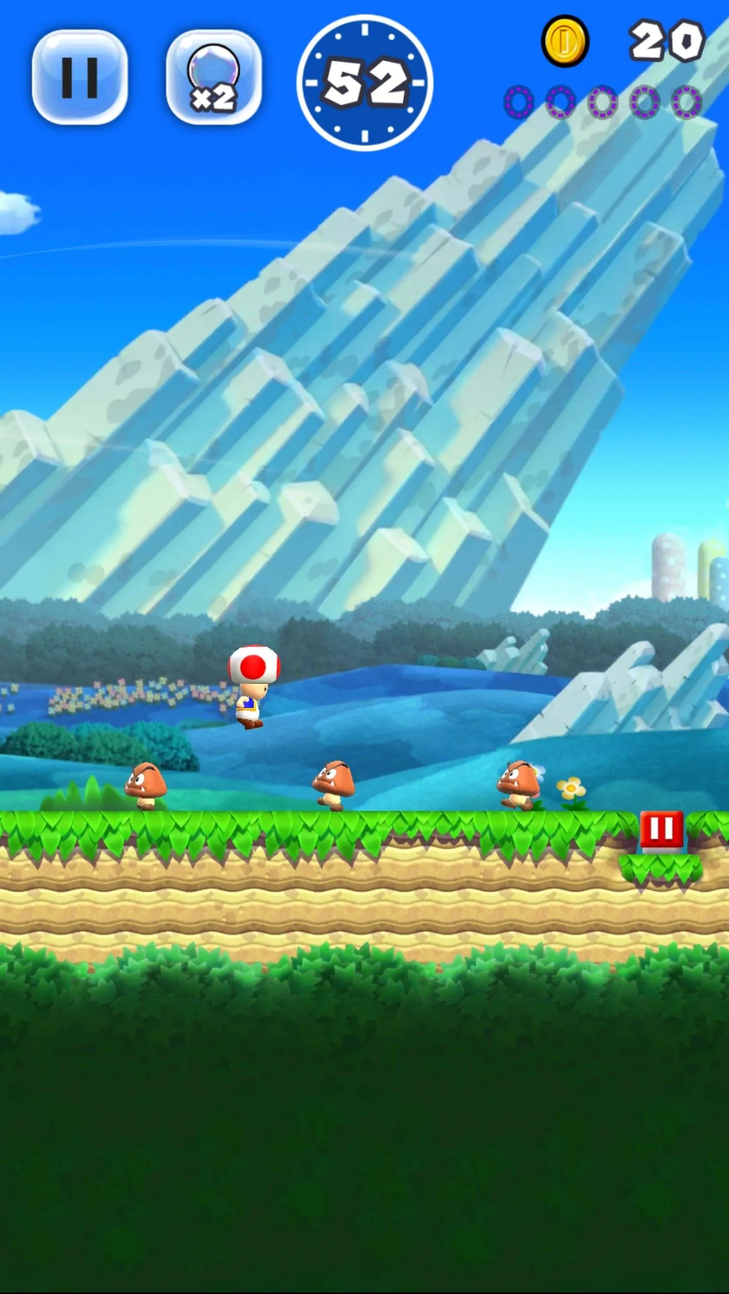 A colorful mobile game landscape featuring a character navigating a platform with obstacles and a mountain in the background.