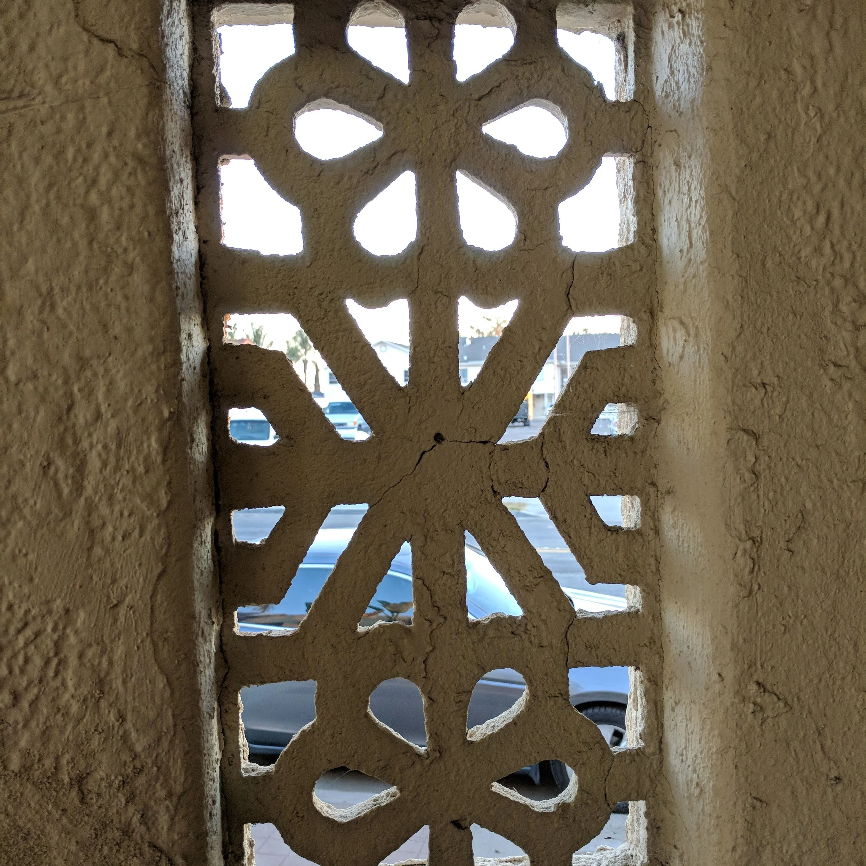 Decorative window grille with intricate patterns.