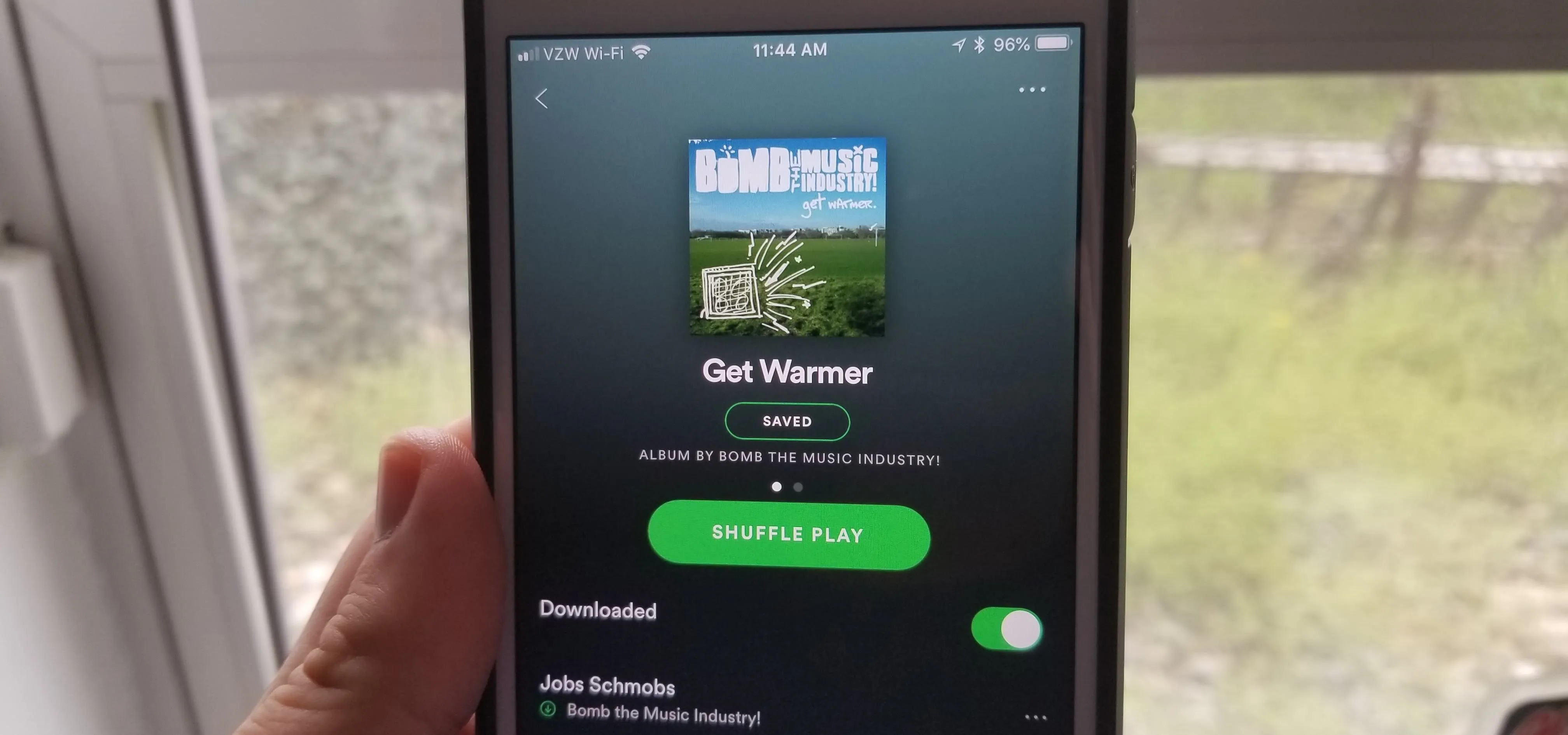 Spotify app displaying a podcast titled "Get Warmer" on a mobile phone.