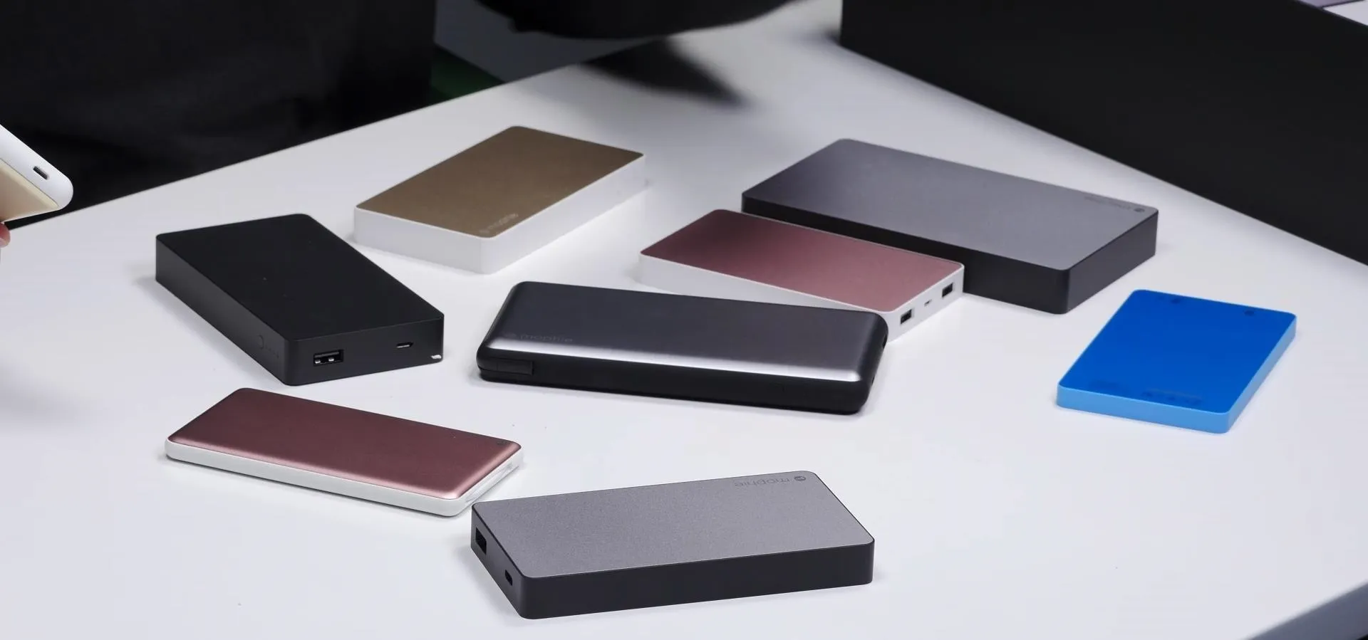 Assorted portable power banks on a table.