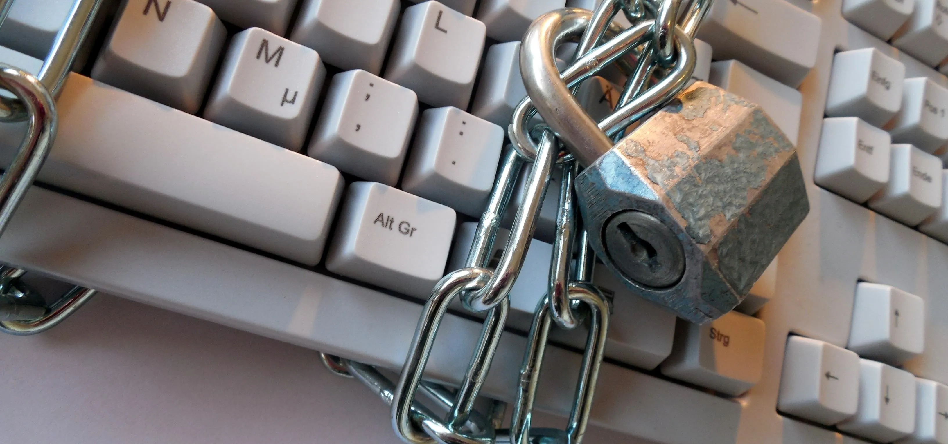 Keyboard locked with a padlock and chain.