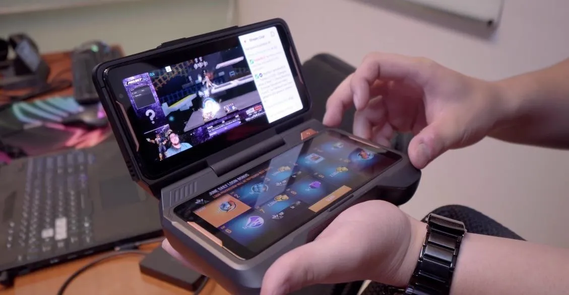 A person holding a portable gaming device displaying a game interface.