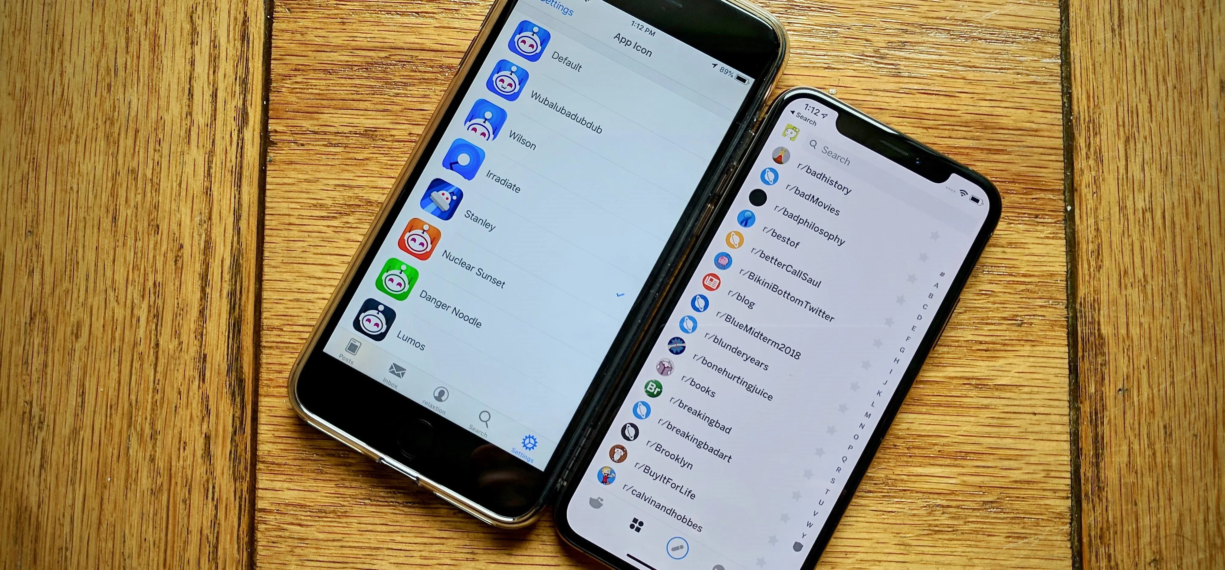 Two smartphones side by side displaying app menus on their screens.