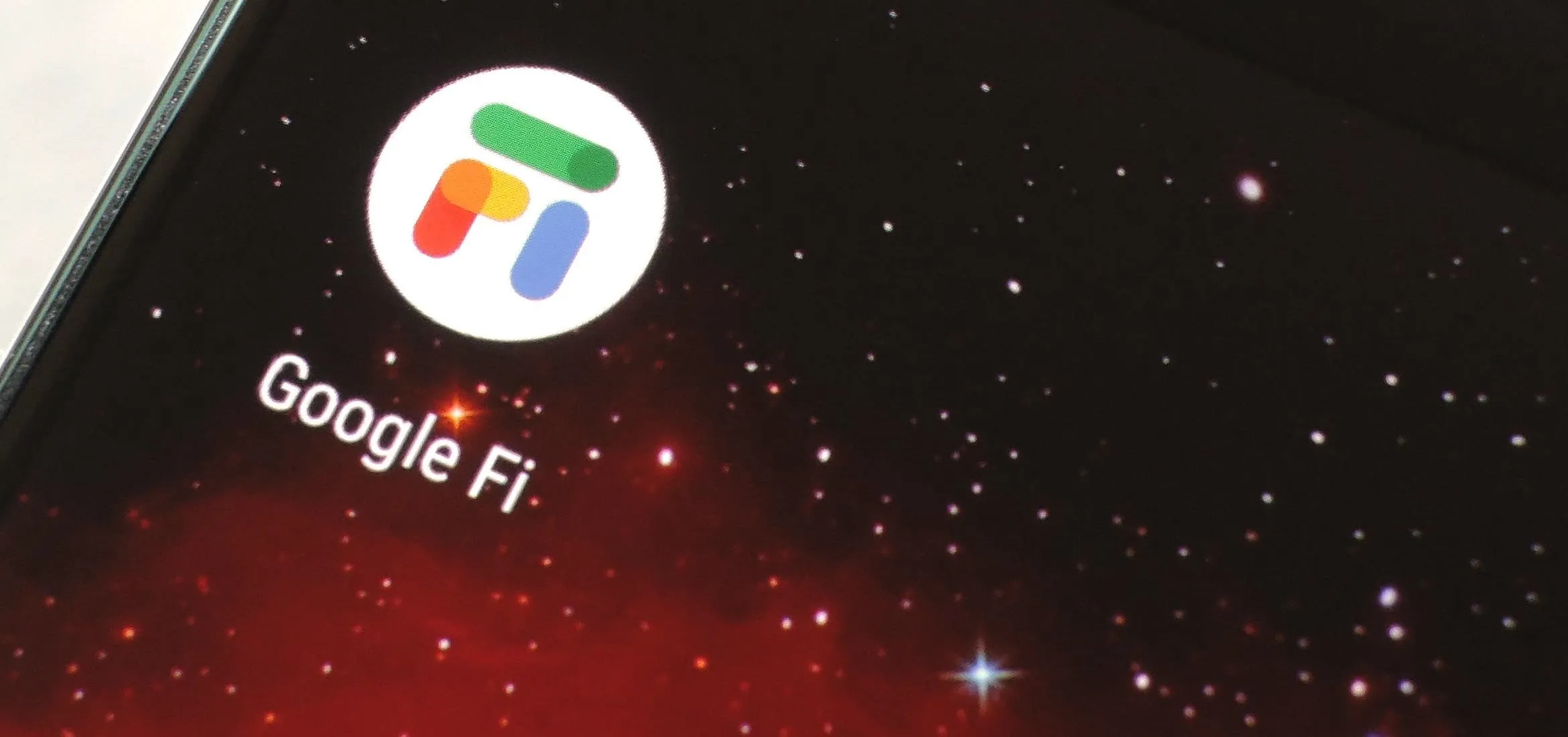 Google Fi logo on a smartphone screen against a cosmic background
