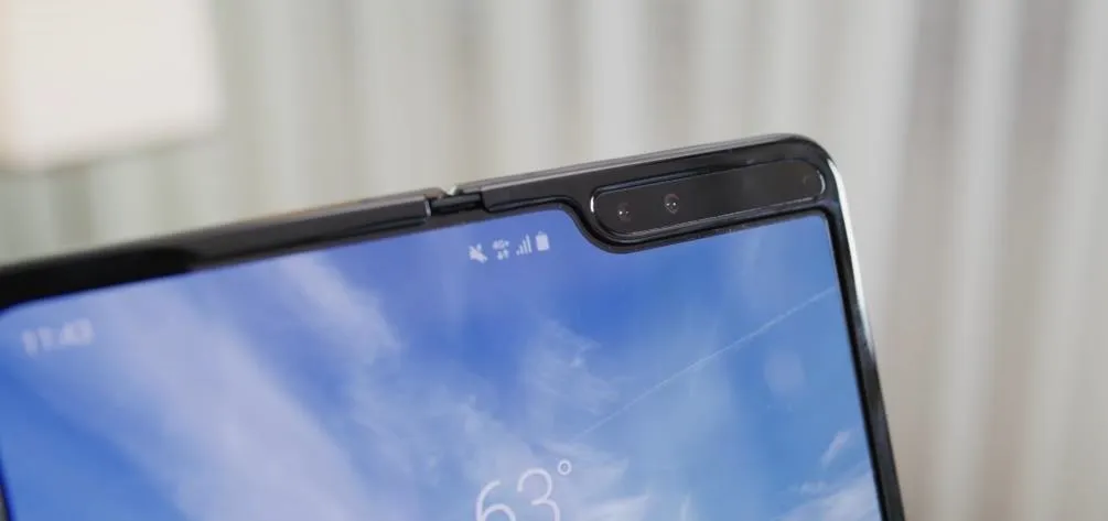 Close-up of the edge of a foldable smartphone displaying the screen and camera.