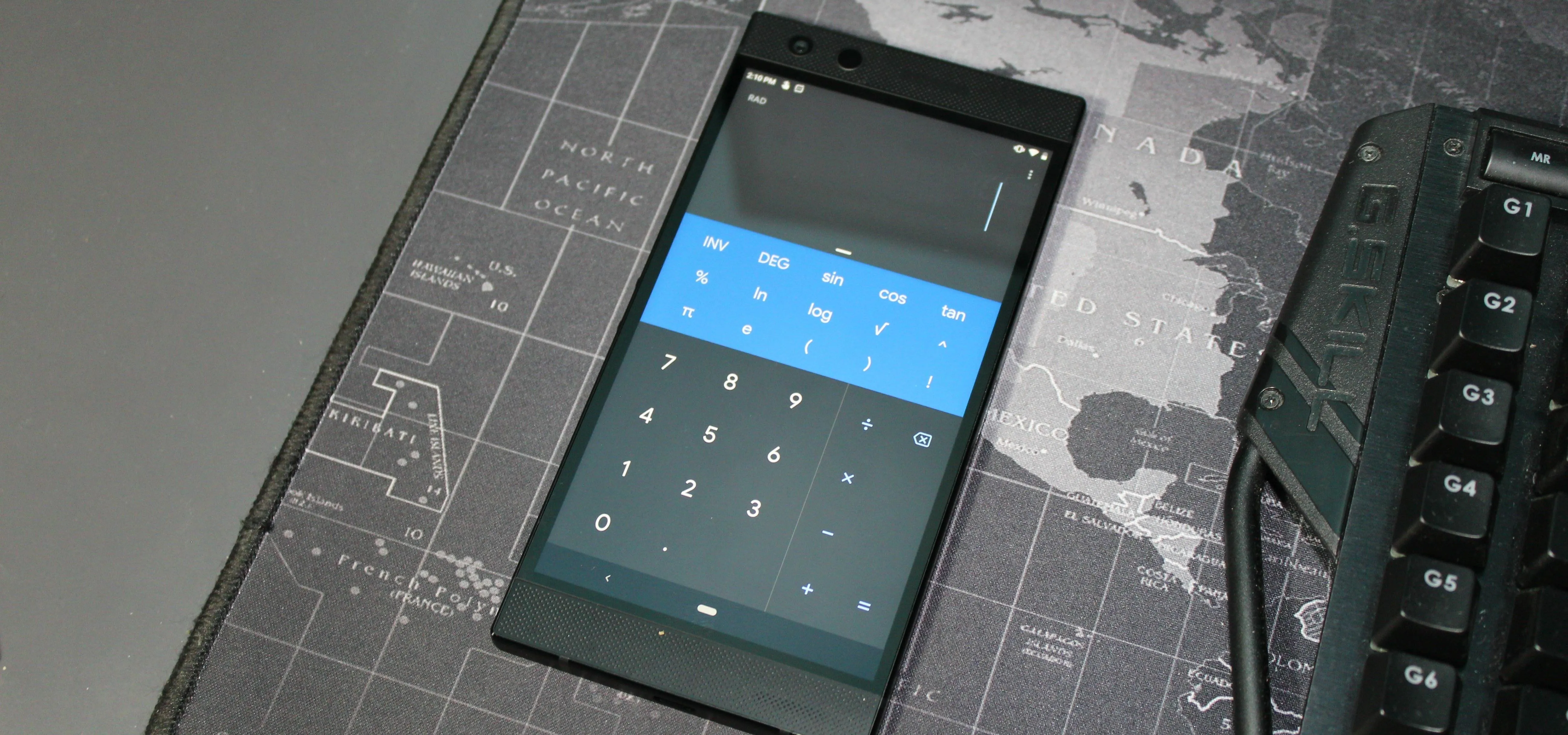 Calculator app open on a smartphone with a map background.