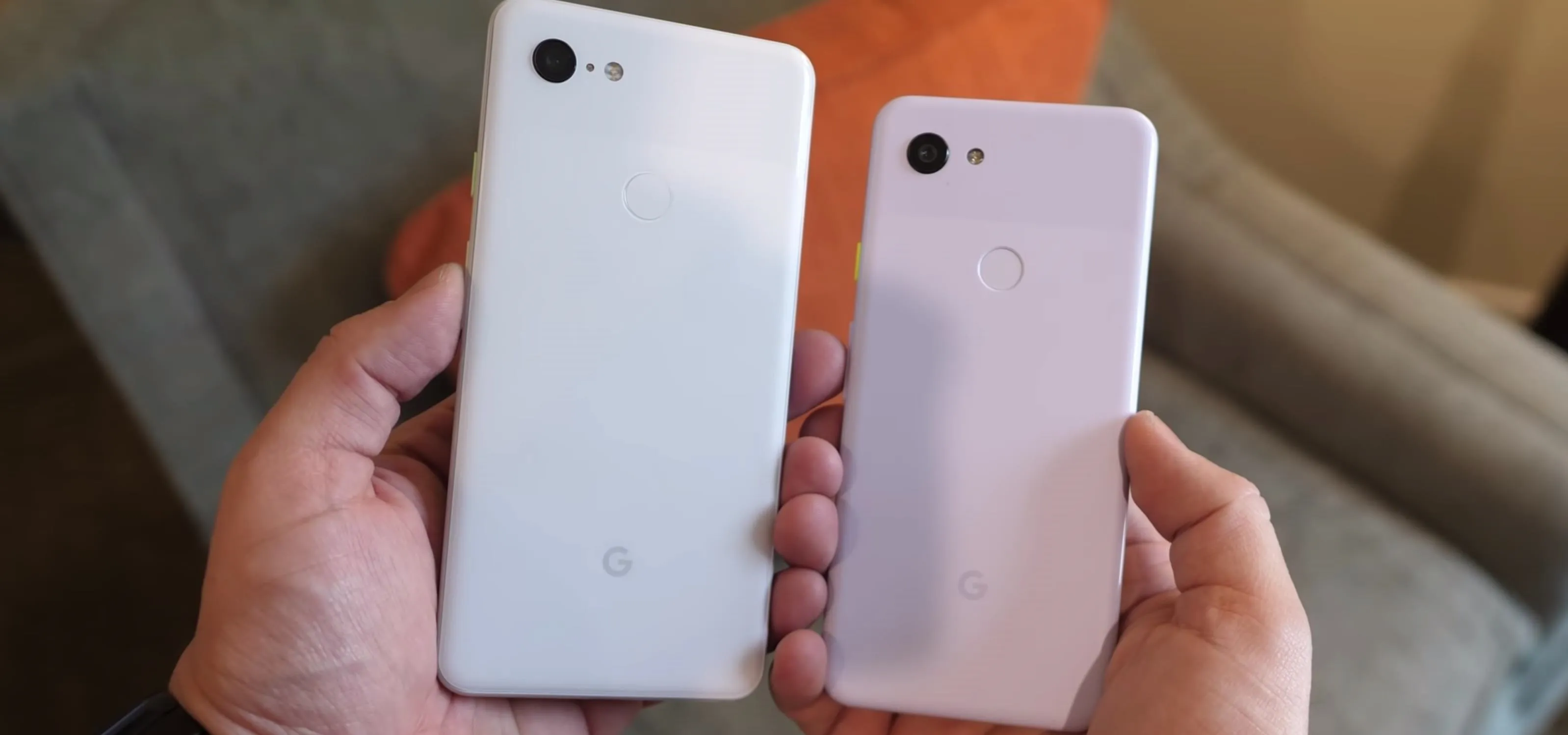 Two smartphones being held in hands, showcasing different sizes and designs.