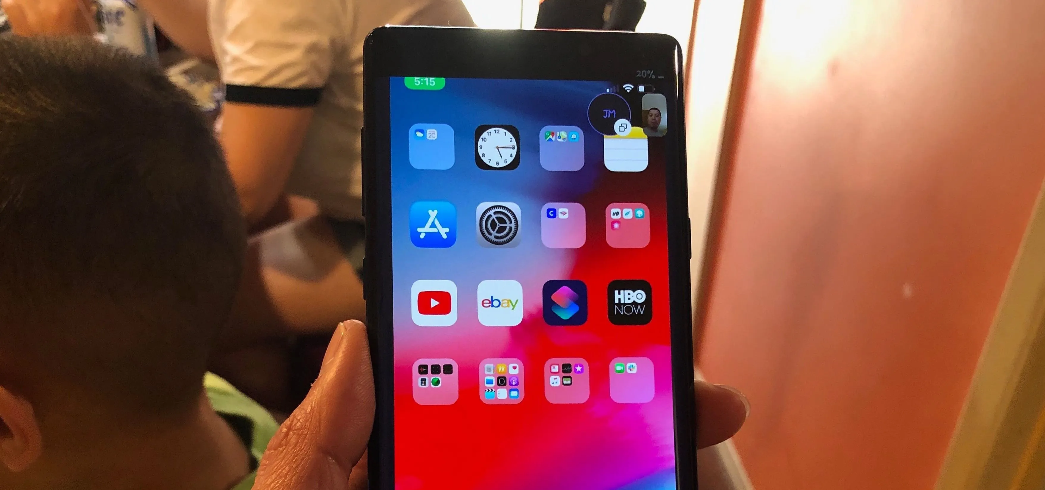 Smartphone displaying various app icons on the home screen.