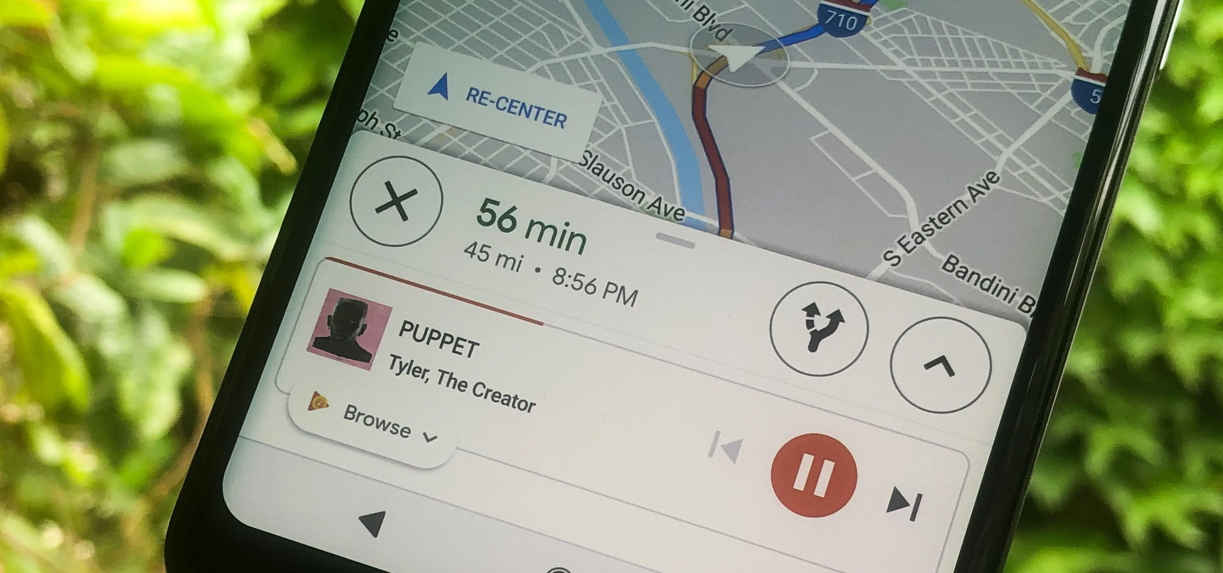 Mobile screen displaying navigation and music playback interface.