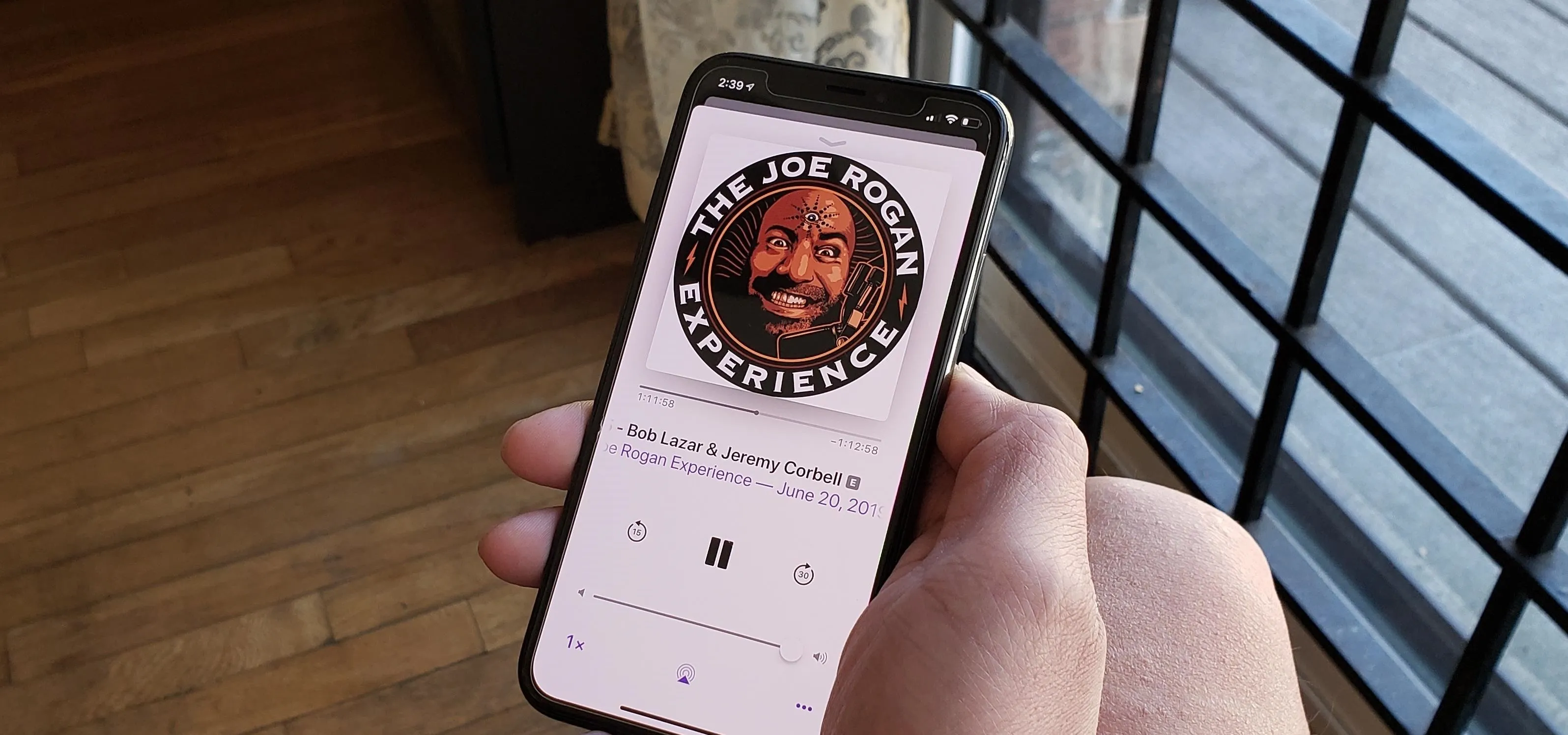 Joe Rogan Experience podcast playing on a smartphone.
