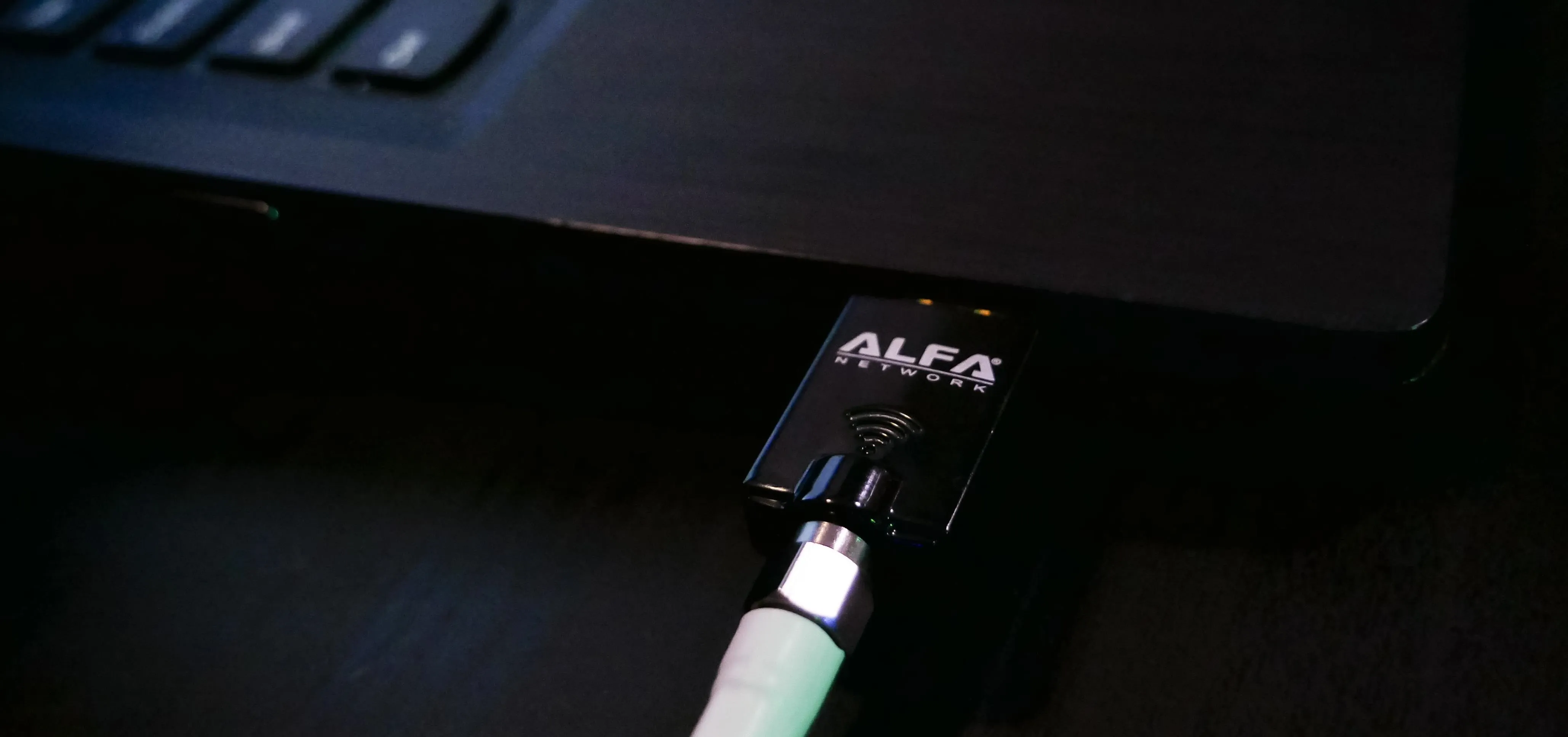 ALFA network adapter connected to a laptop.