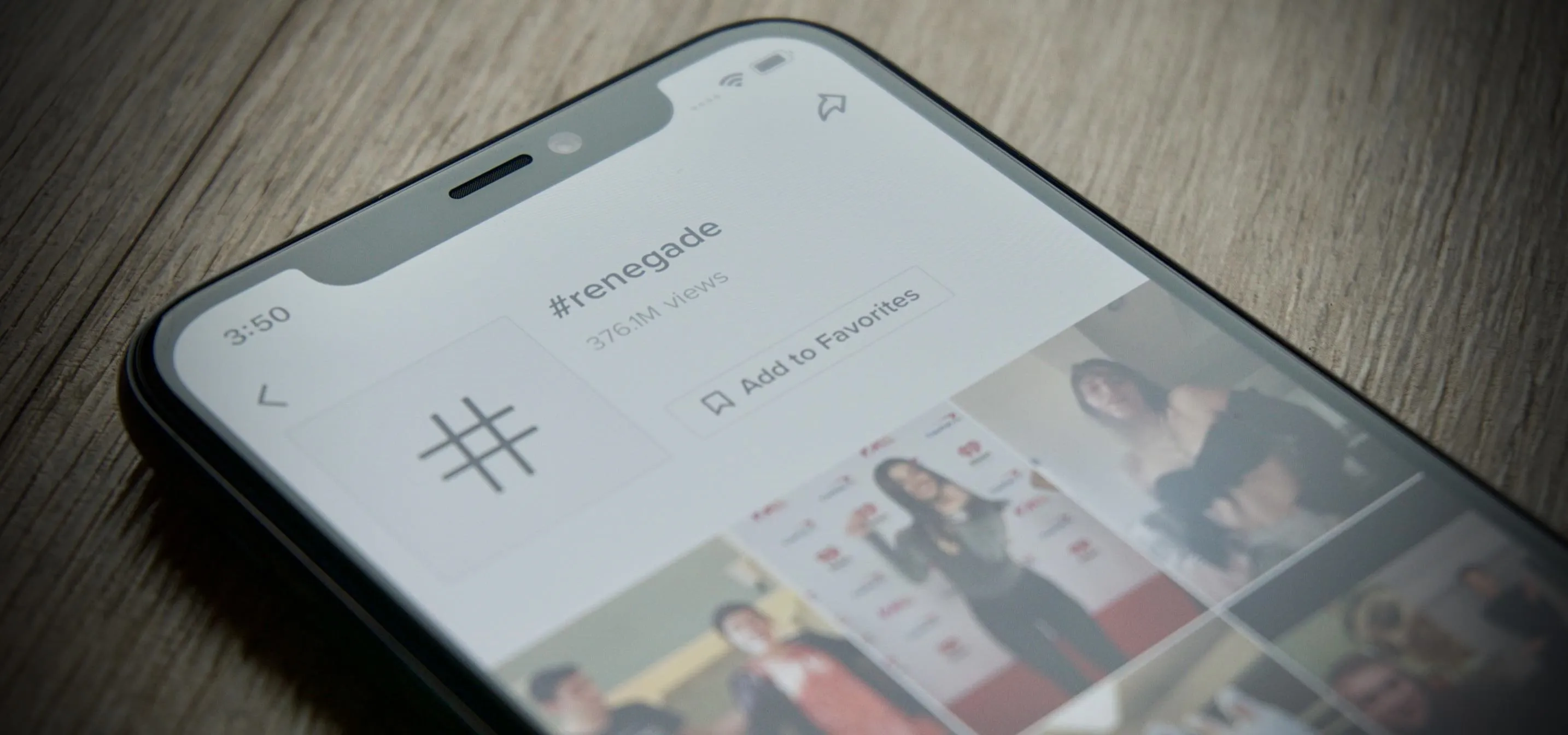 Mobile phone displaying a social media profile and images.