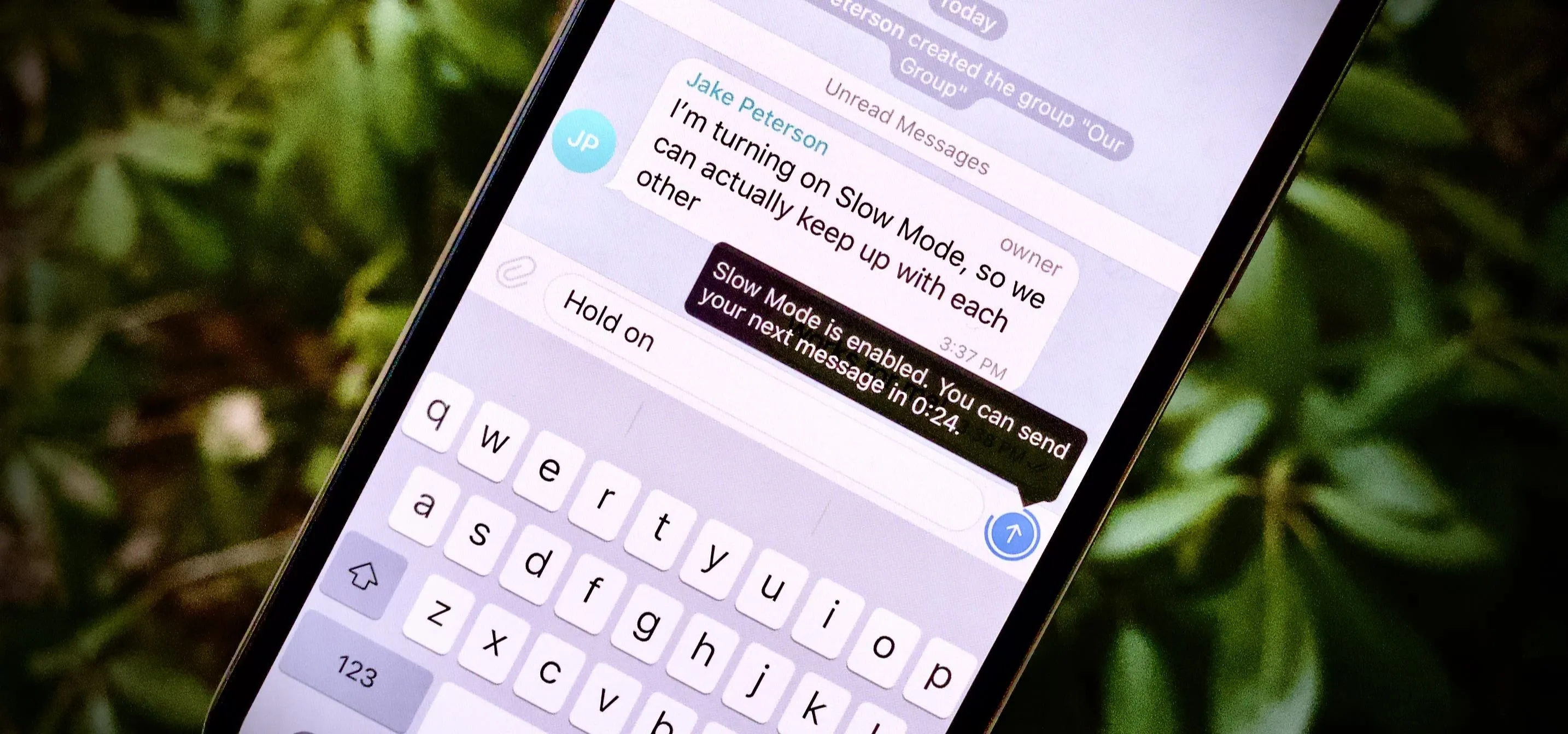 Text conversation on a smartphone with a blurred natural background.