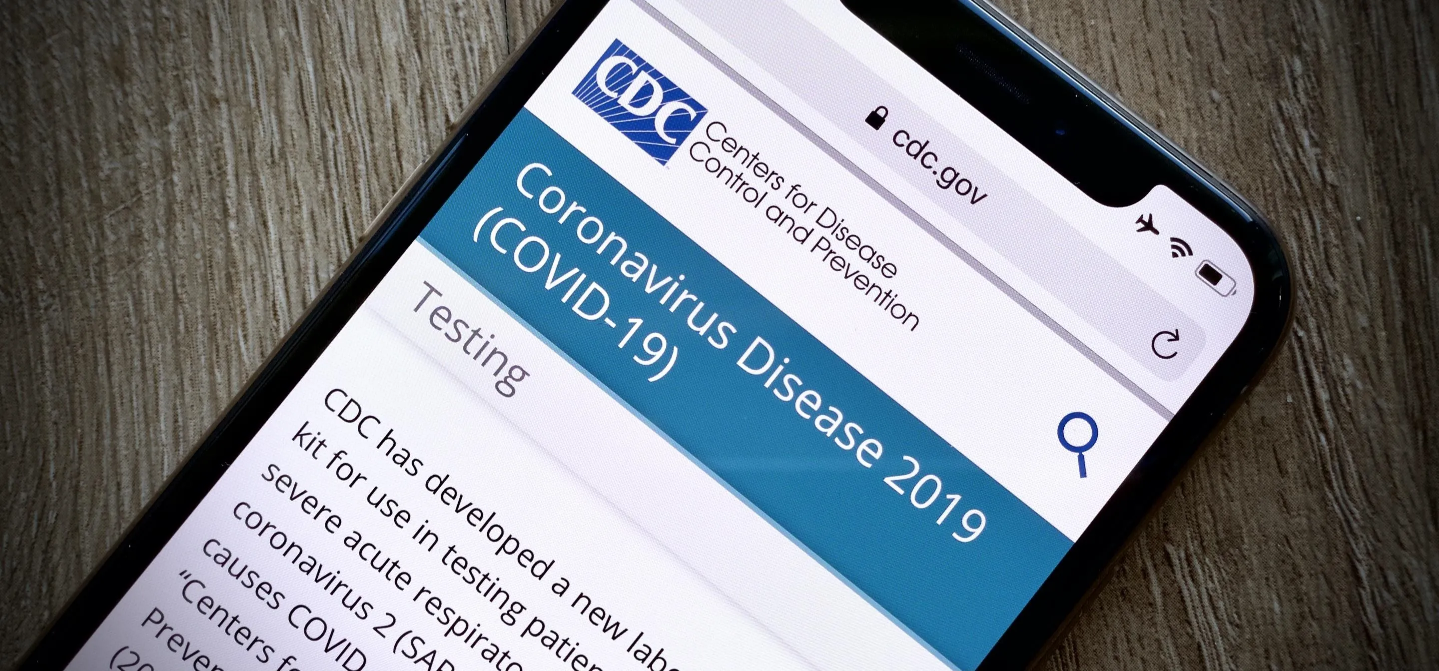 Smartphone displaying CDC information about Coronavirus Disease 2019 (COVID-19) testing.