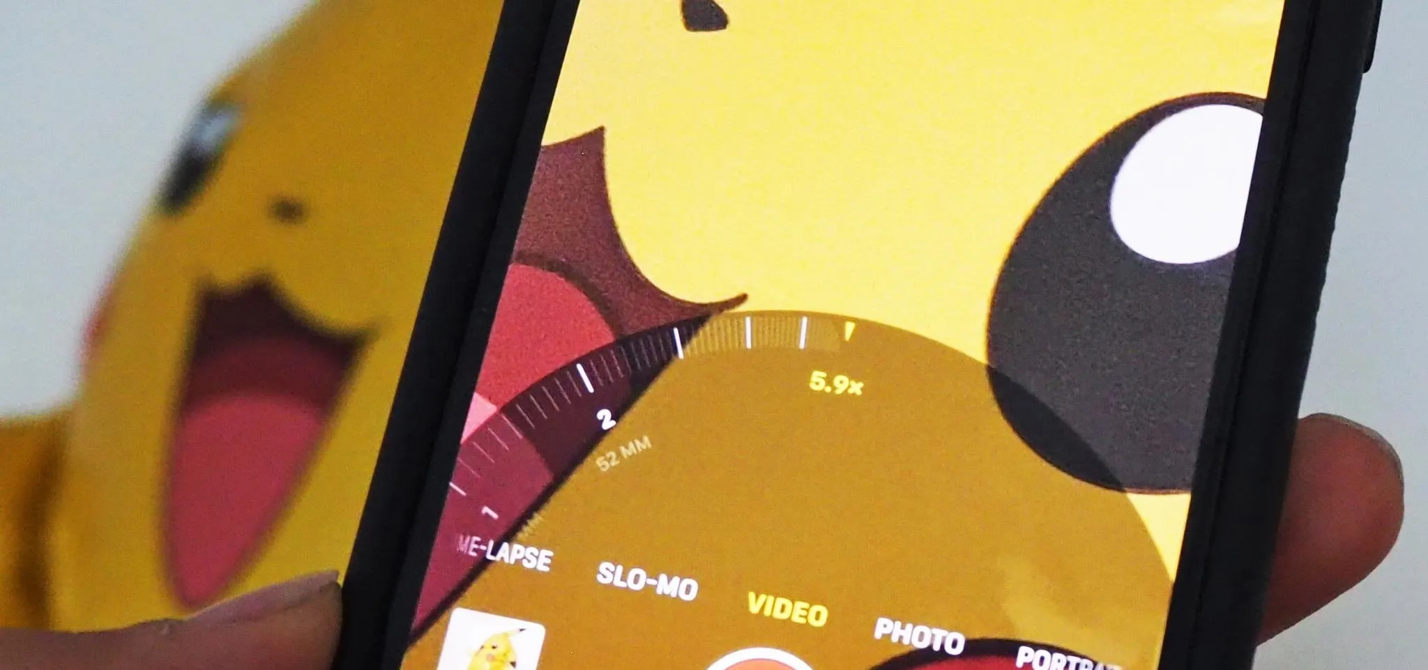 Close-up of a smartphone displaying a Pikachu-themed interface.