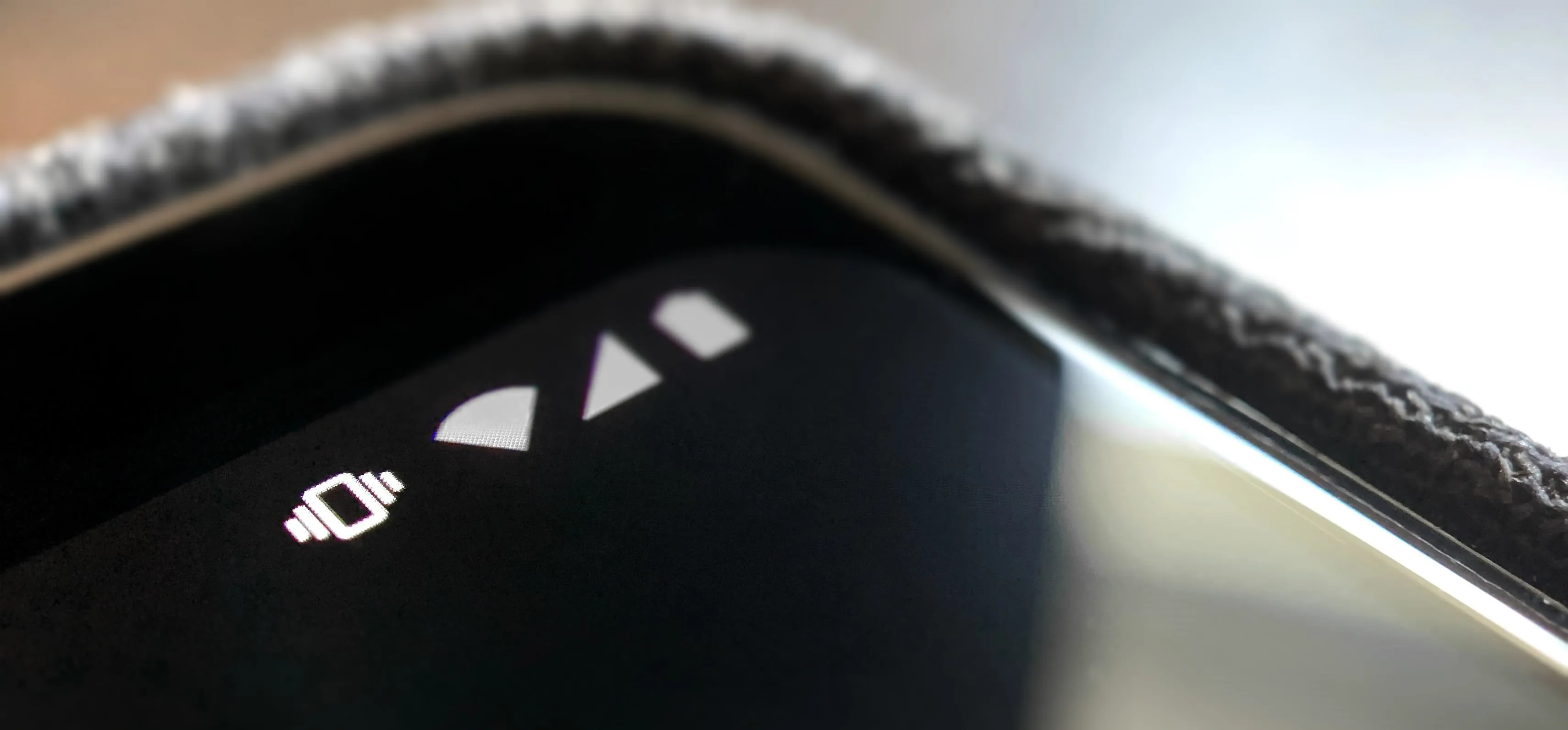 Close-up of a smartphone screen displaying signal and battery icons.