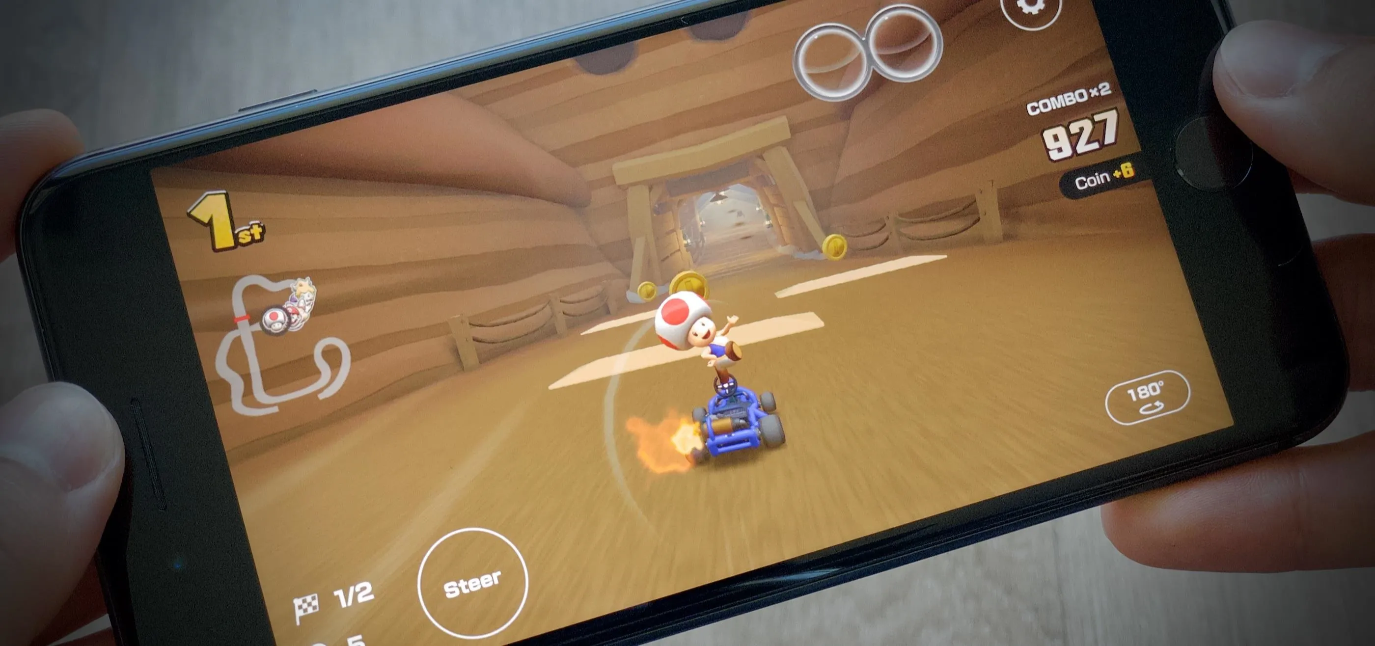 A person playing a racing game on a smartphone.