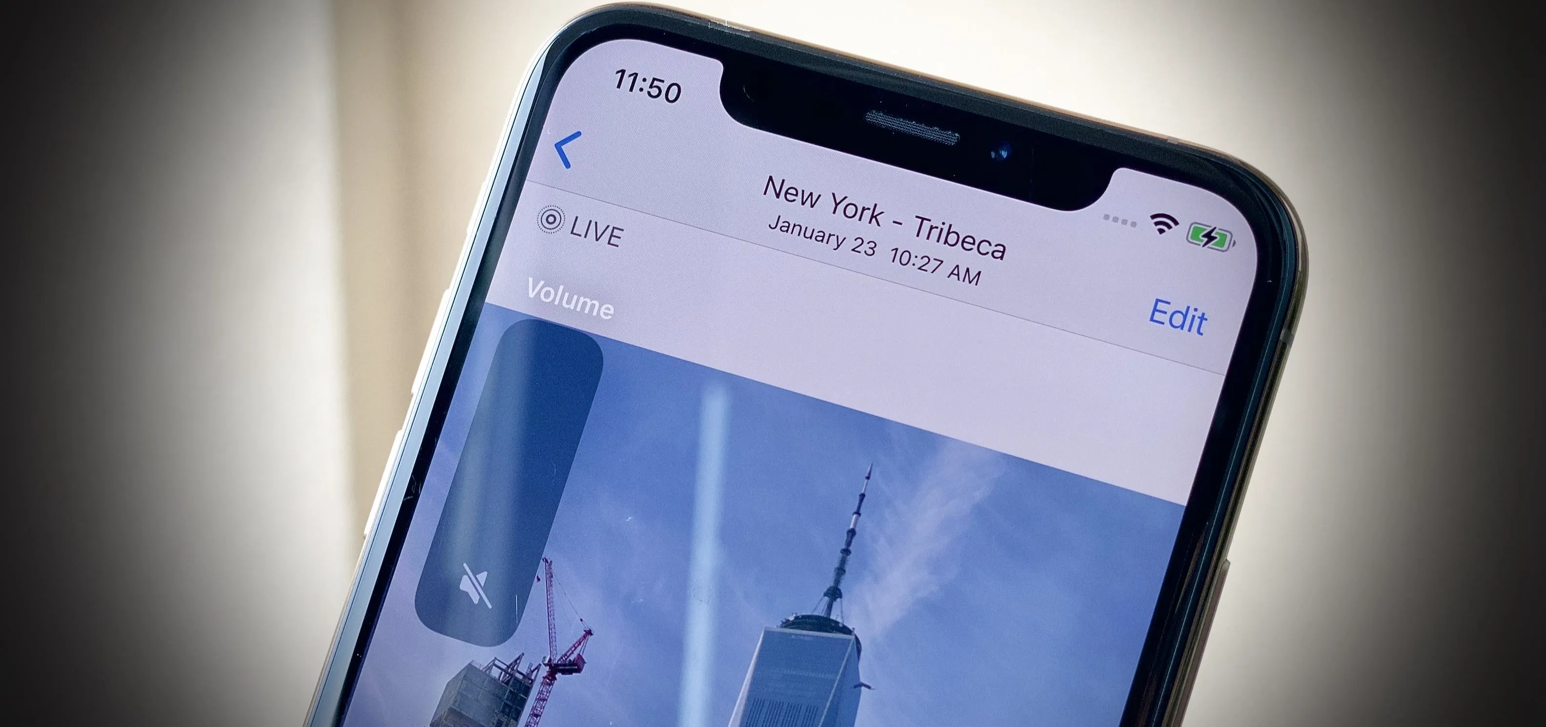 Image of a smartphone displaying a photograph of the One World Trade Center in New York City.