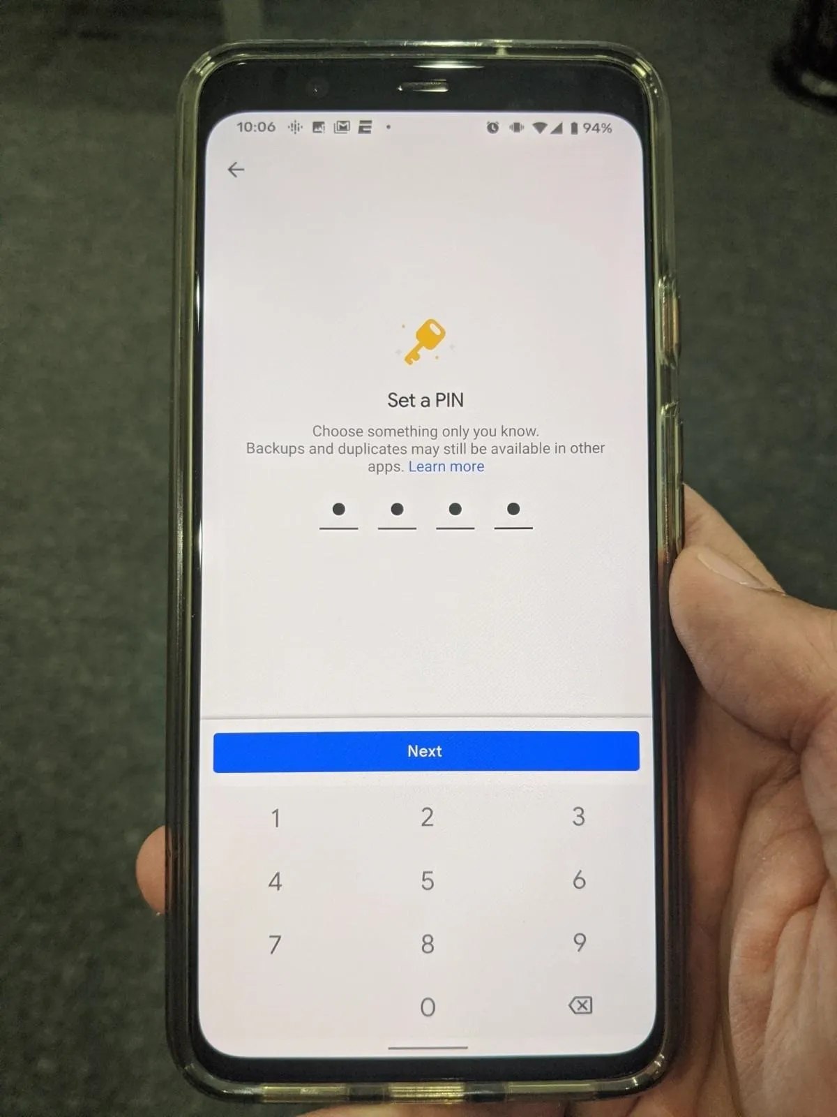 Login screen on a smartphone with a keypad for entering credentials.