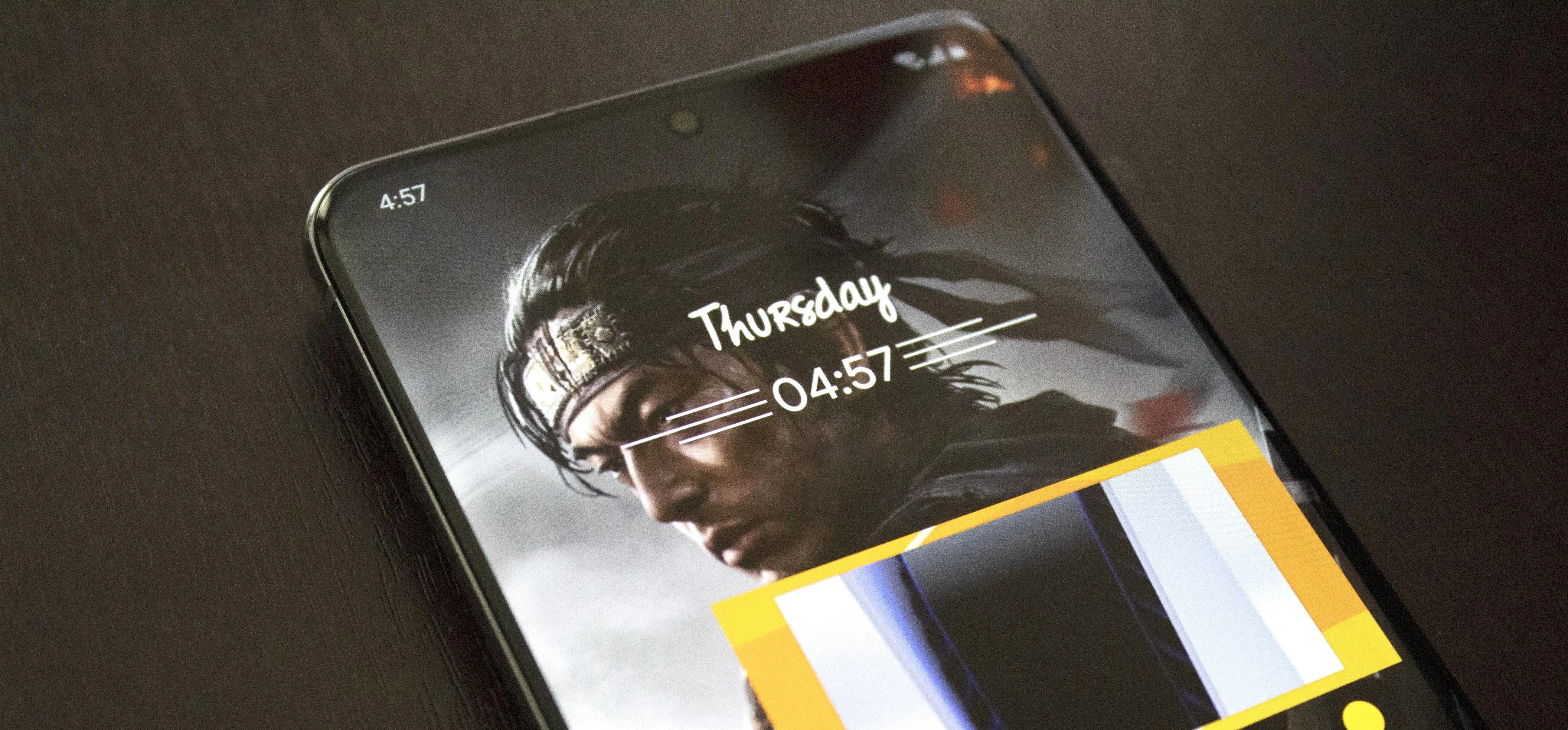 Smartphone display showing time and a blurred background image.