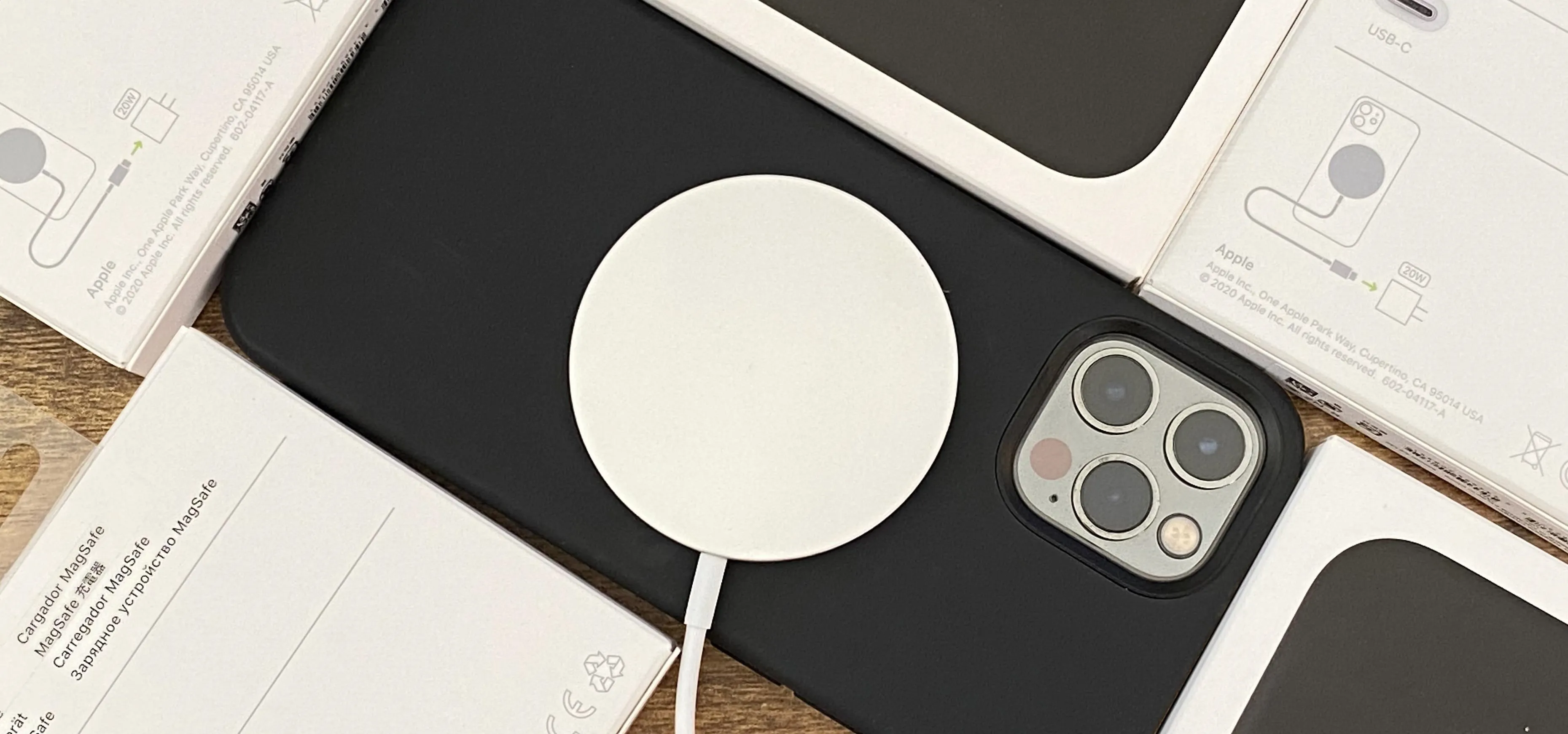 Wireless charger placed on a smartphone with packaging in the background.