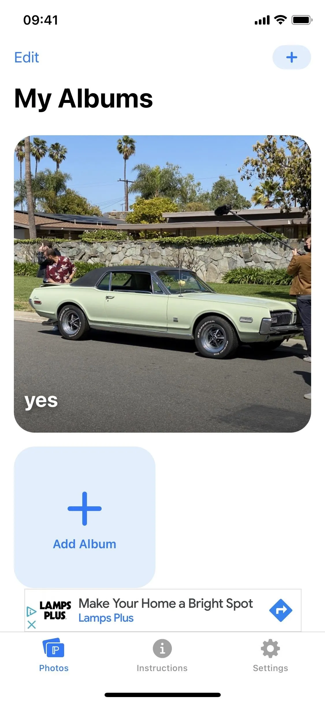 Classic car parked on a street with palm trees in the background.