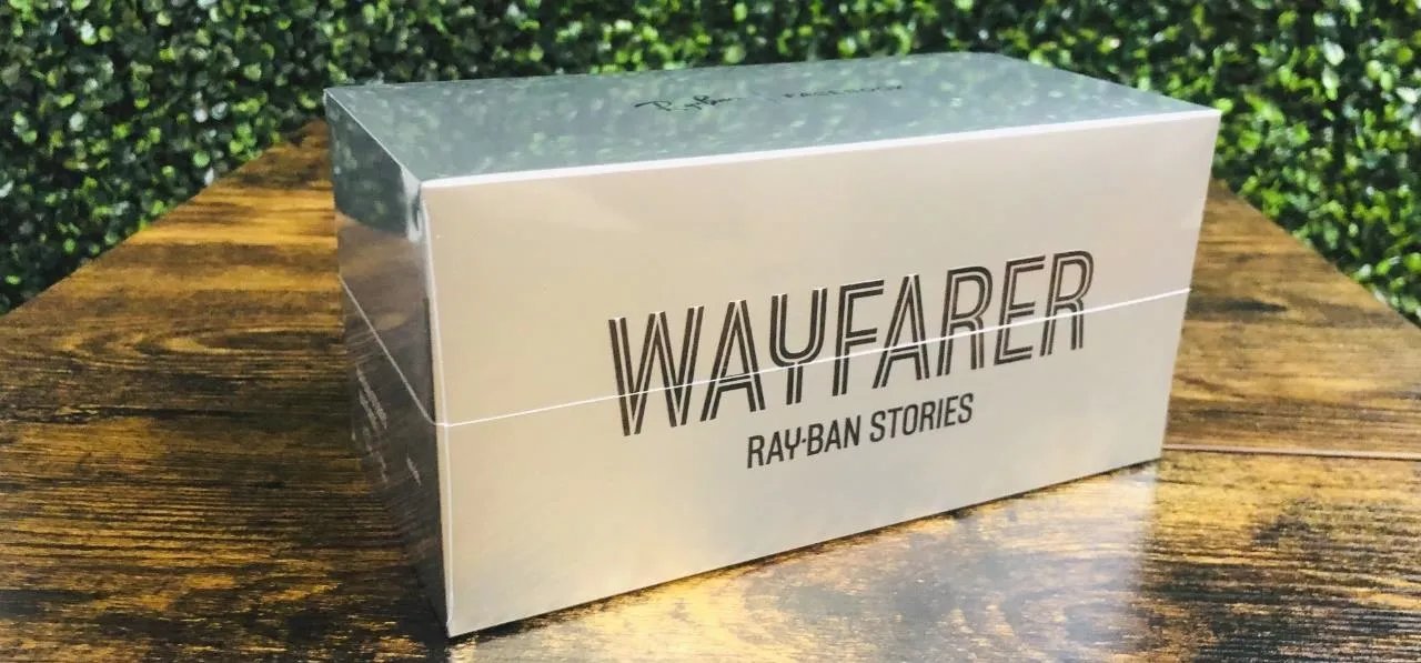 Wayfarer sunglasses box packaging on a wooden surface.