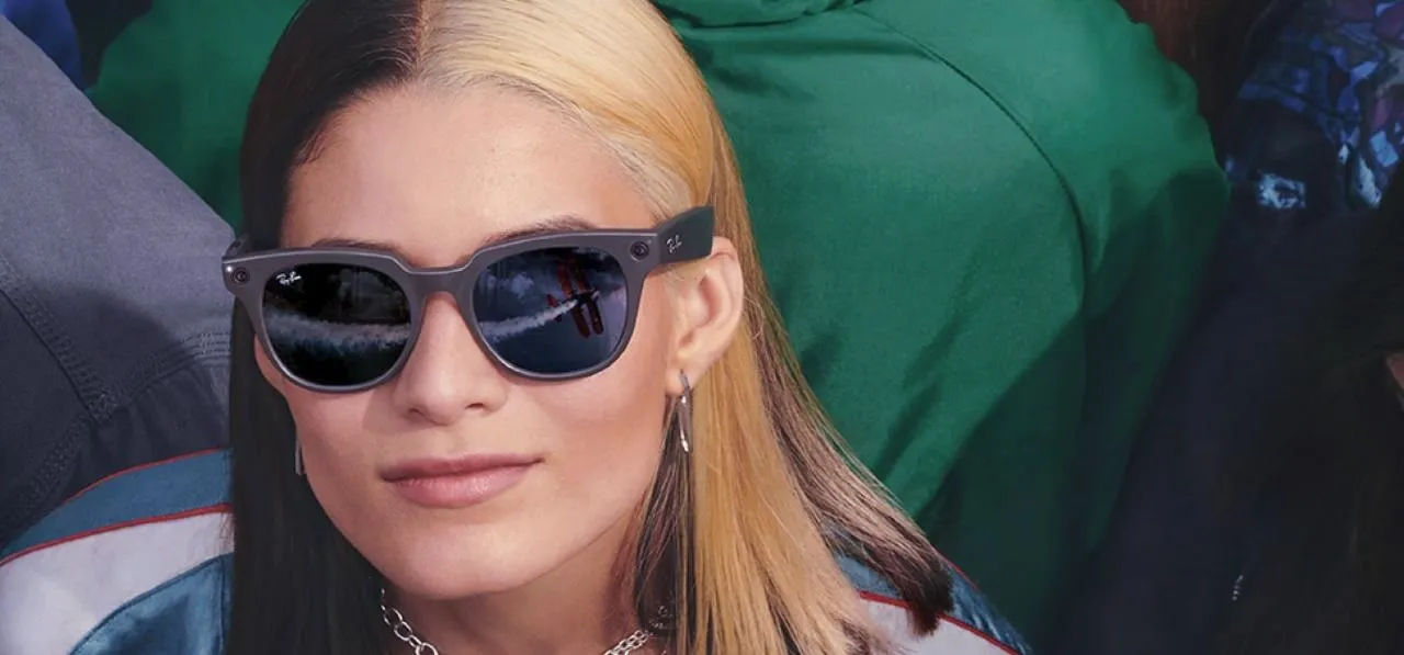 Young woman wearing sunglasses with a distinctive two-tone hairstyle.