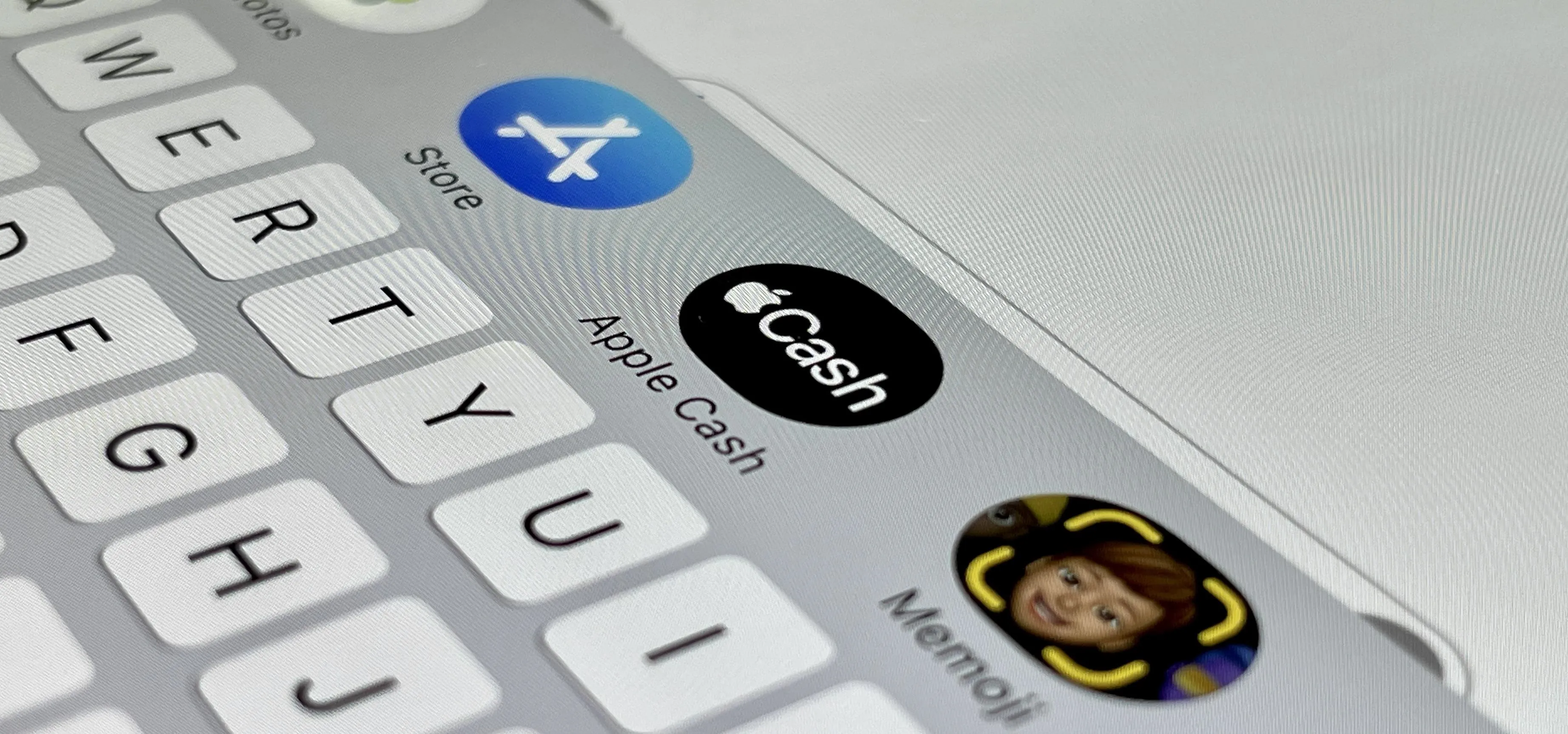 Icons of a smartphone keyboard featuring App Store, Apple Cash, and Memoji.
