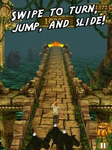 Image of a jungle-themed video game interface with instructions to swipe to turn, jump, and slide on a stone bridge.