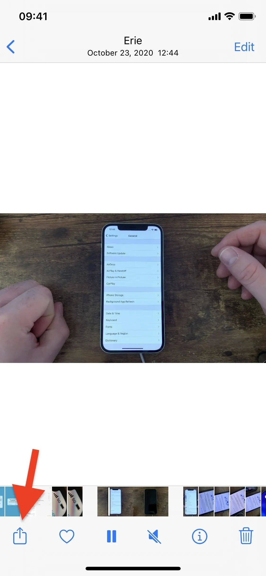 A person holding a phone displaying a screen, with hands positioned near the device.