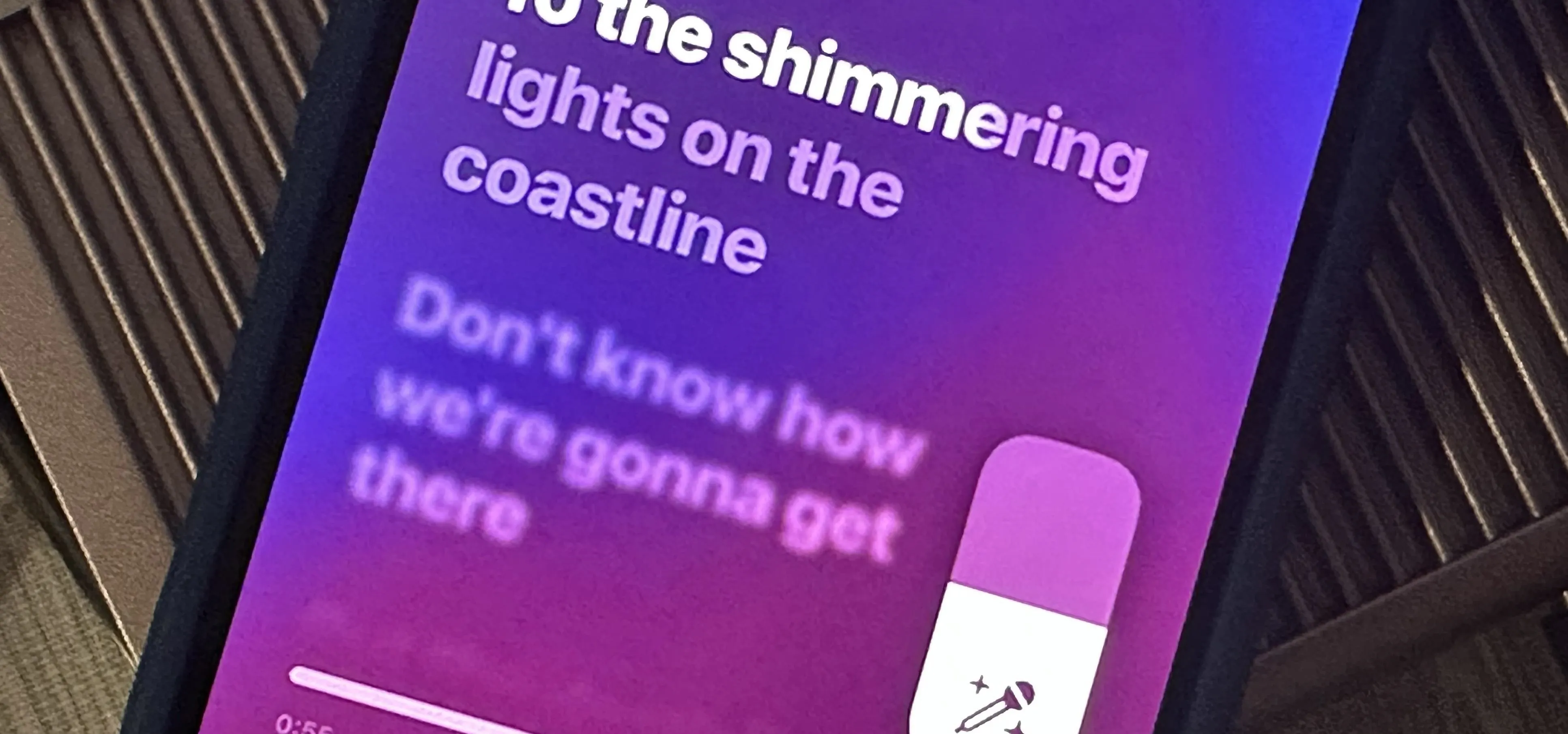 Screenshot of a mobile app interface displaying a song lyric about shimmering lights on the coastline.
