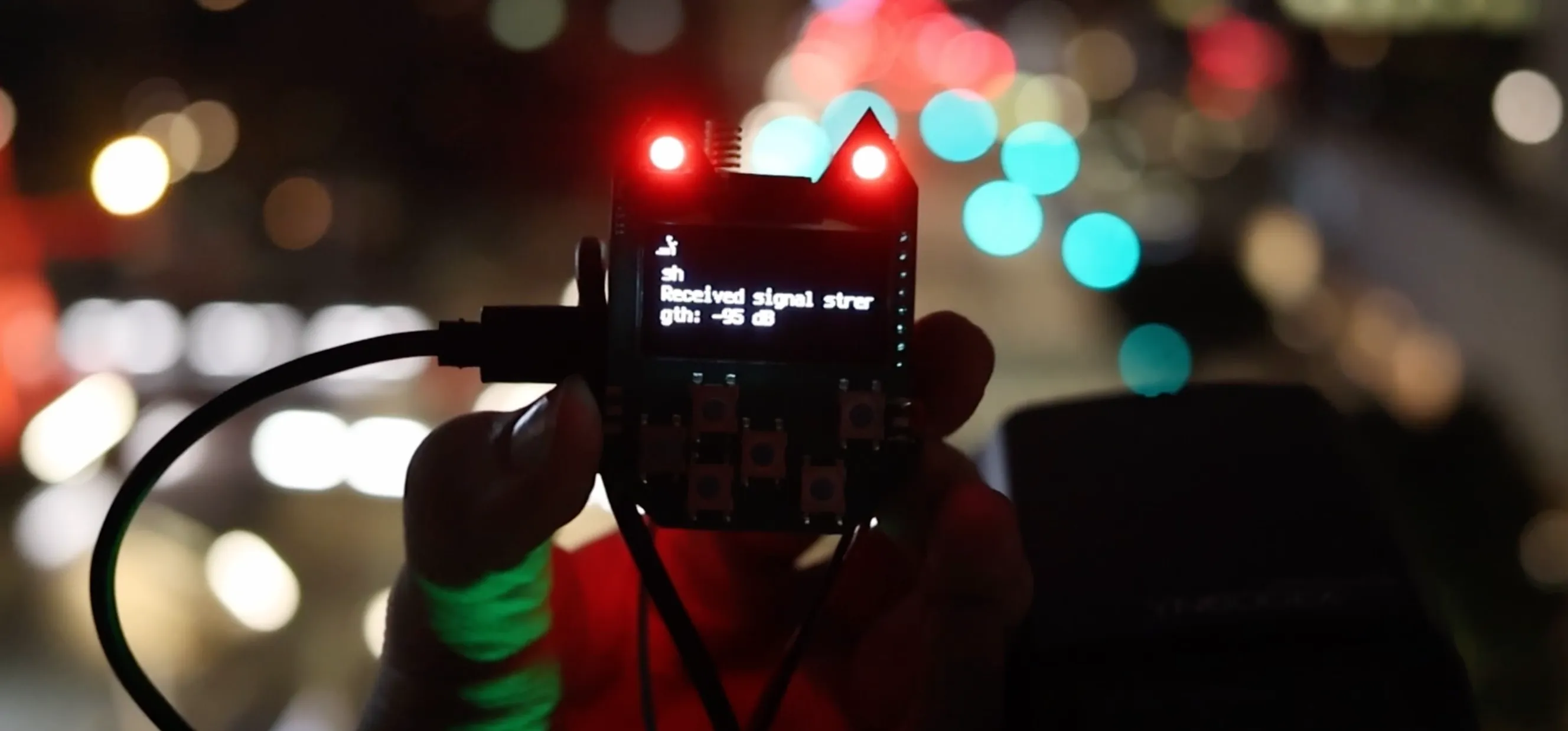 A USB Nugget with LoRa module showing the received signal strength from another LoRa module.