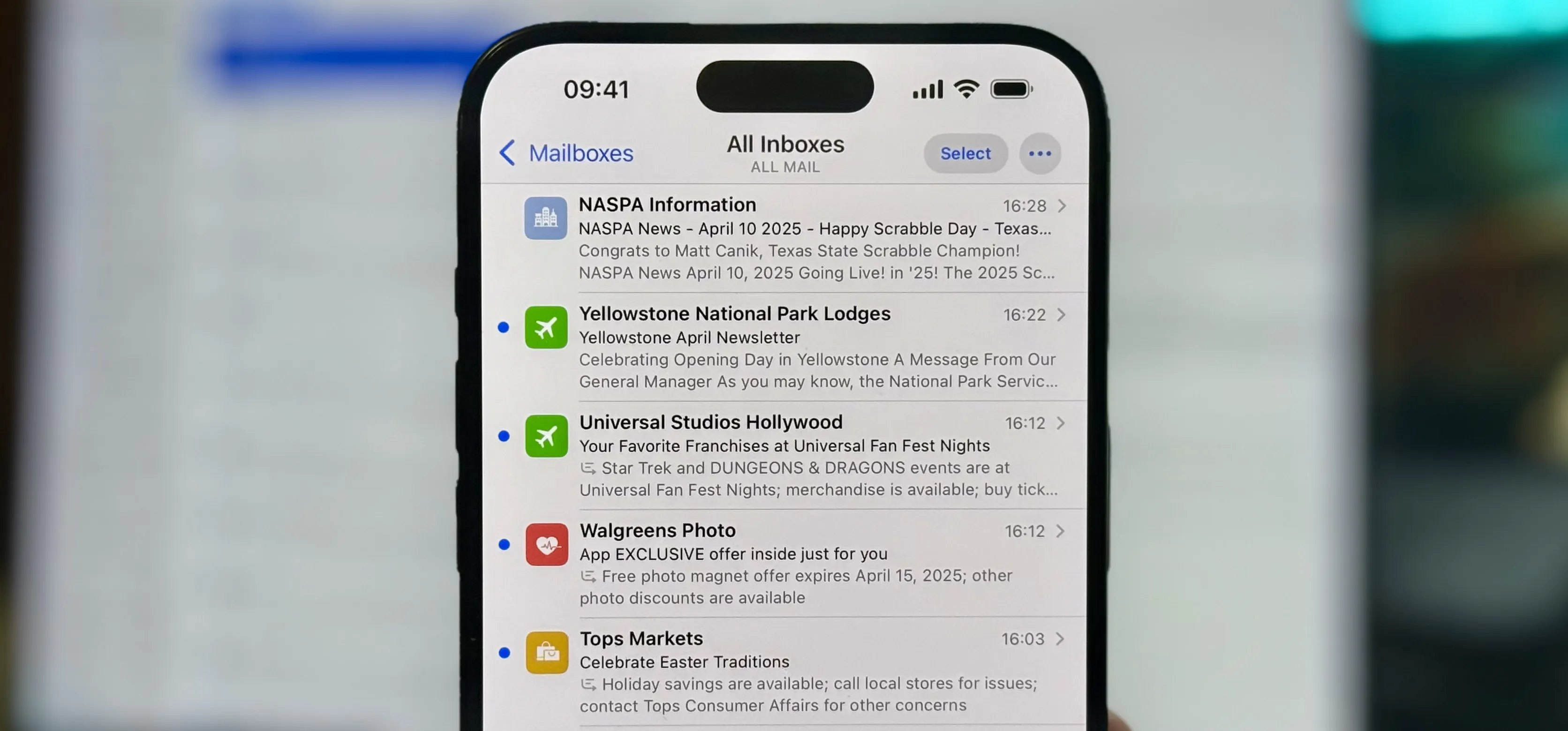 Mail app inbox on iPhone showing contact photos for senders, including NASPA, Yellowstone Lodges, Universal Studios, Walgreens, and Tops Markets, in iOS 18.4.